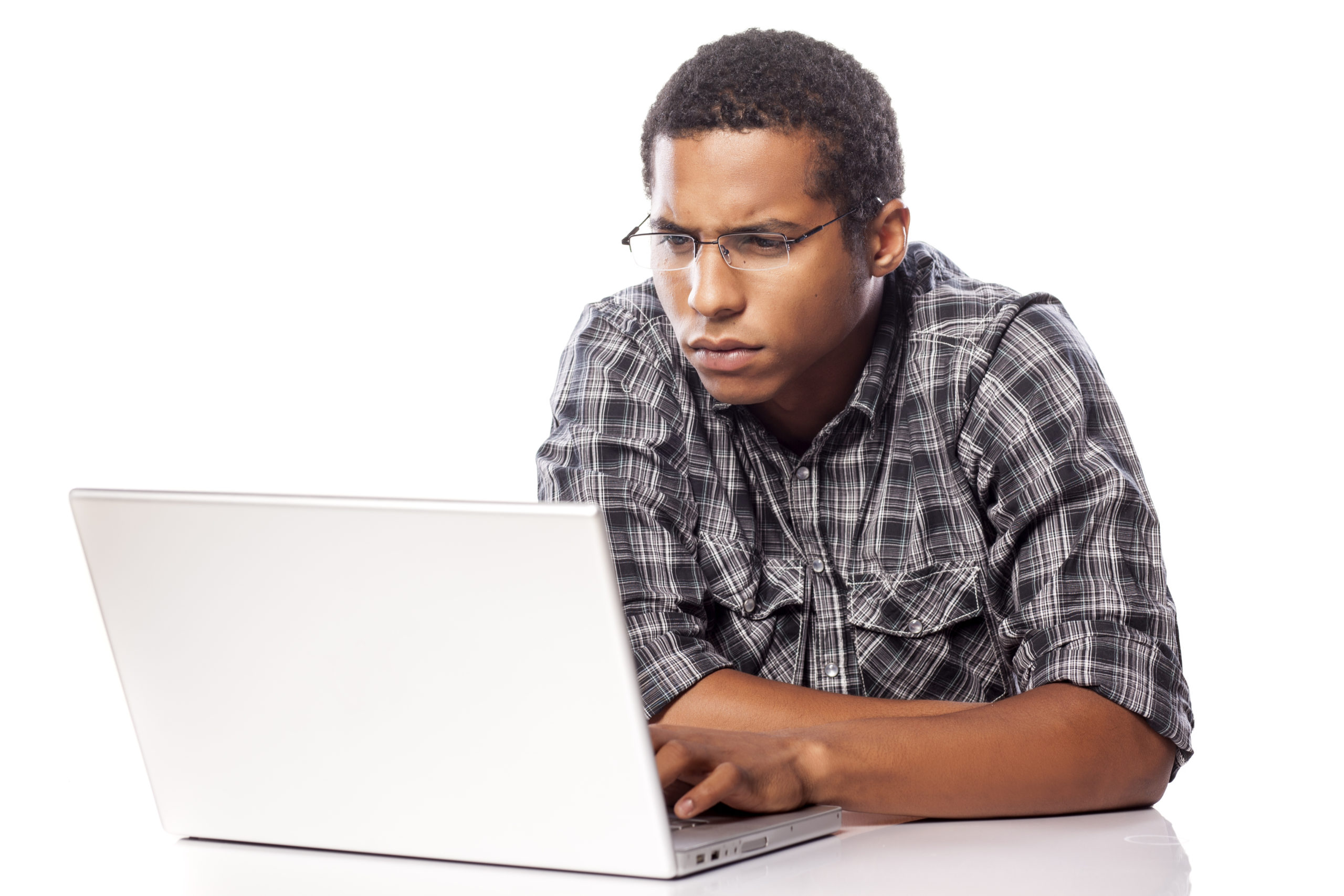 serious dark-skinned man concentrated working on his laptop
